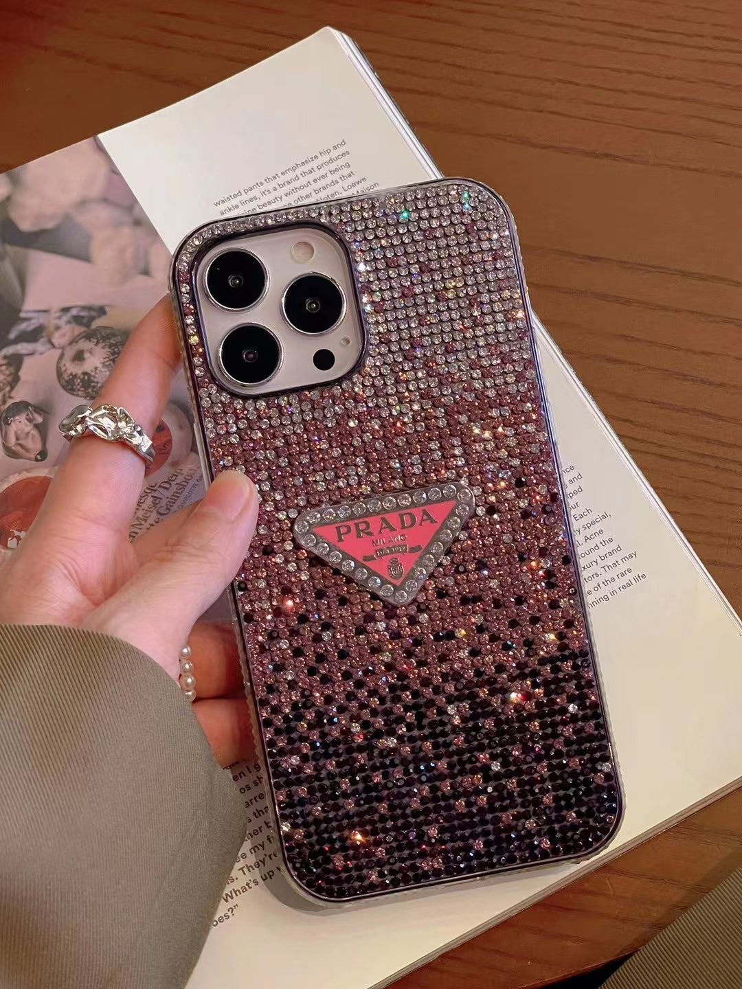 Luxury Prada Diamond iPhone Case protecting iPhone on a desk.