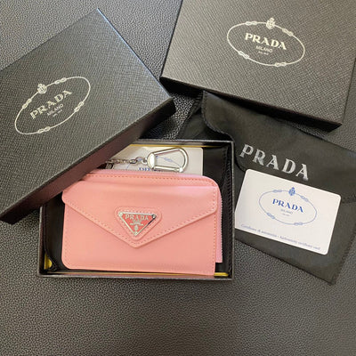 An array of PRADA Classic Card Holder Wallets in various colors, including black, red, and pastel shades.