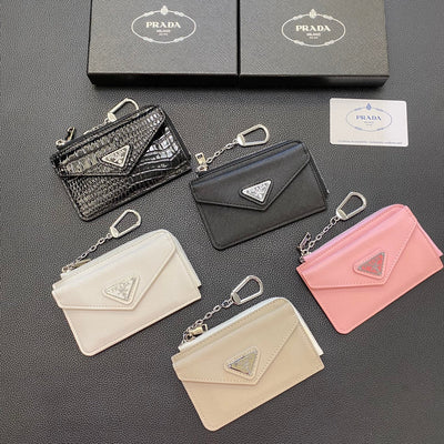 A close-up of a black PRADA Classic Card Holder Wallet with the iconic PRADA logo subtly embossed on the front